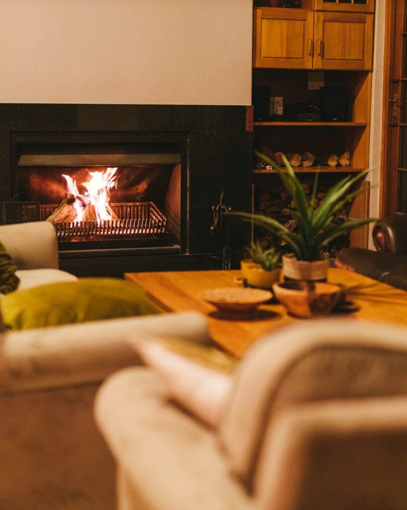 Warm living room with a sofa, rug, and lamp in evening light